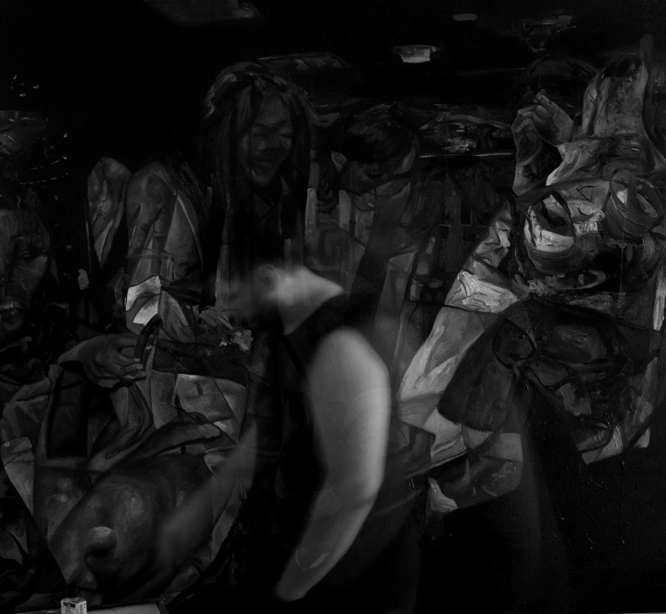 The artist moving in front of a large painting
